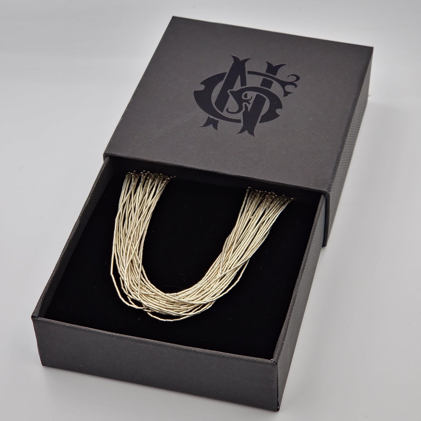 Collar artesanal de plata líquida 925 con 24 hilos finamente trabajados a mano, diseño largo y sofisticado que refleja luz con elegancia. Hecho por artesanos mexicanos, ideal para un estilo refinado y atemporal.