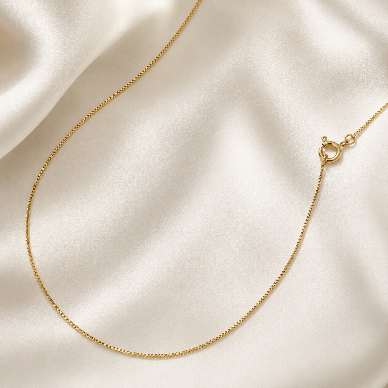 Elevate your everyday look with the timeless elegance of our 18k Gold Filled Venetian Box Chain. Featuring sleek, geometric links that capture light from every angle, this durable chain offers a smooth, luxurious drape. Wear it solo for a clean statement or layer it effortlessly with your favorite pendants.