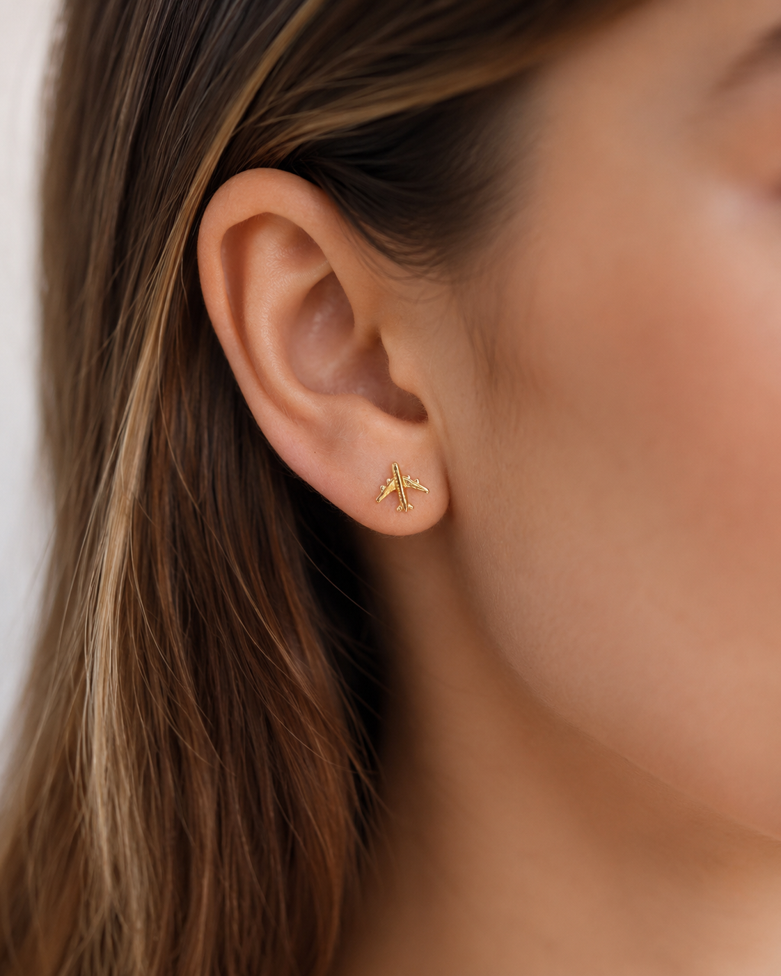 Carry the spirit of adventure. Our 18k Gold Filled airplane studs are hypoallergenic, waterproof, and travel-proof. The perfect 0.27" (0.7cm) gift for the modern jet-setter. Shop Nosso Galeon.