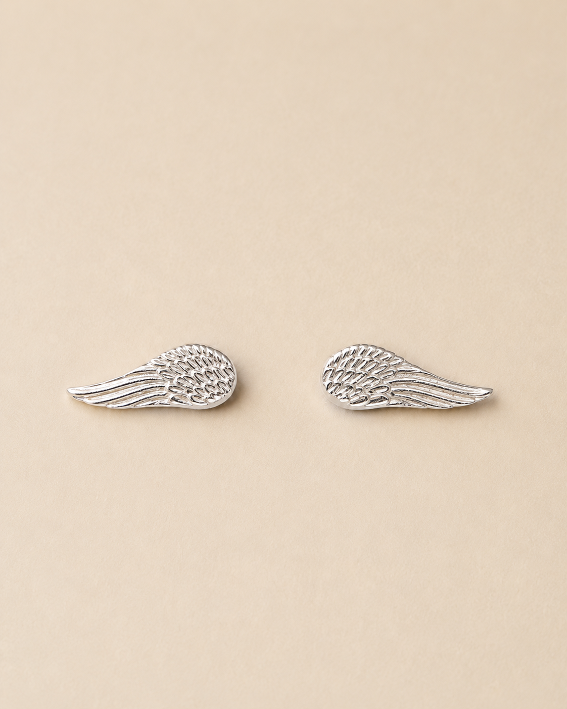 Handcrafted angel wing stud earrings in Colombian 925 sterling silver. A delicate symbol of freedom, hope, and new beginnings. Ethically made by hand.
