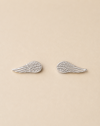 Handcrafted angel wing stud earrings in Colombian 925 sterling silver. A delicate symbol of freedom, hope, and new beginnings. Ethically made by hand.