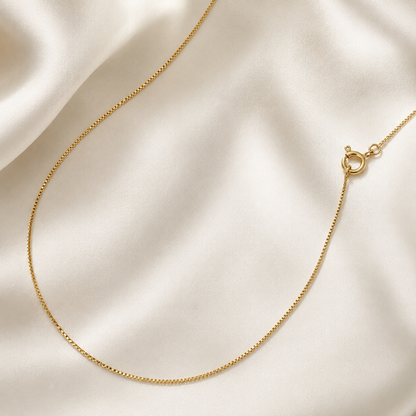 Elevate your everyday look with the timeless elegance of our 18k Gold Filled Venetian Box Chain. Featuring sleek, geometric links that capture light from every angle, this durable chain offers a smooth, luxurious drape. Wear it solo for a clean statement or layer it effortlessly with your favorite pendants.