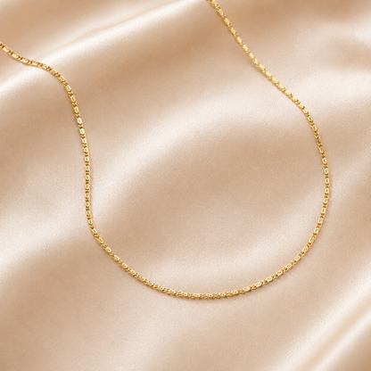  18 inch gold filled snail chain necklace on champagne beige silk, elegant luxury flat lay