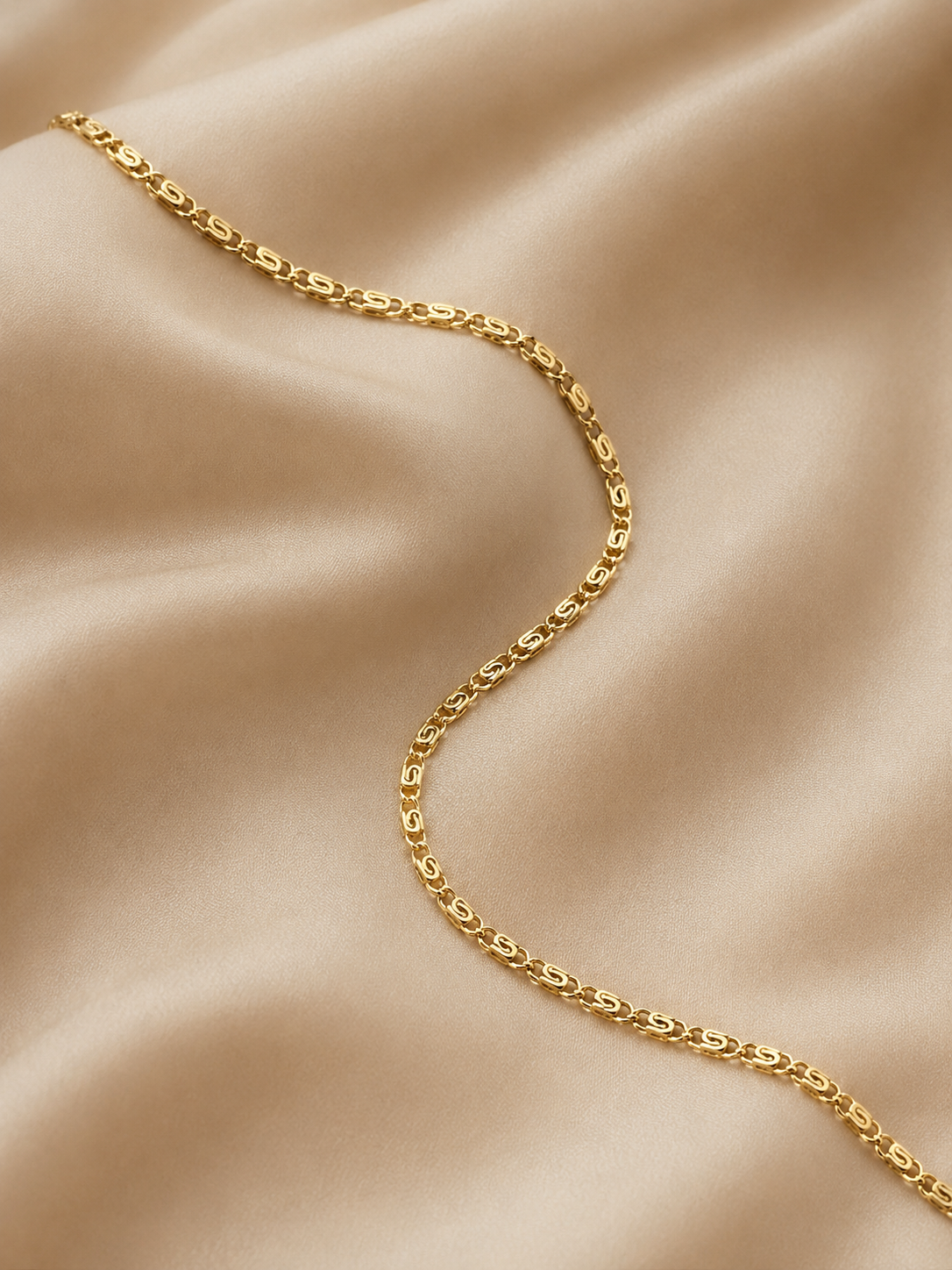 18 inch gold filled snail chain necklace on champagne beige silk, elegant luxury flat lay